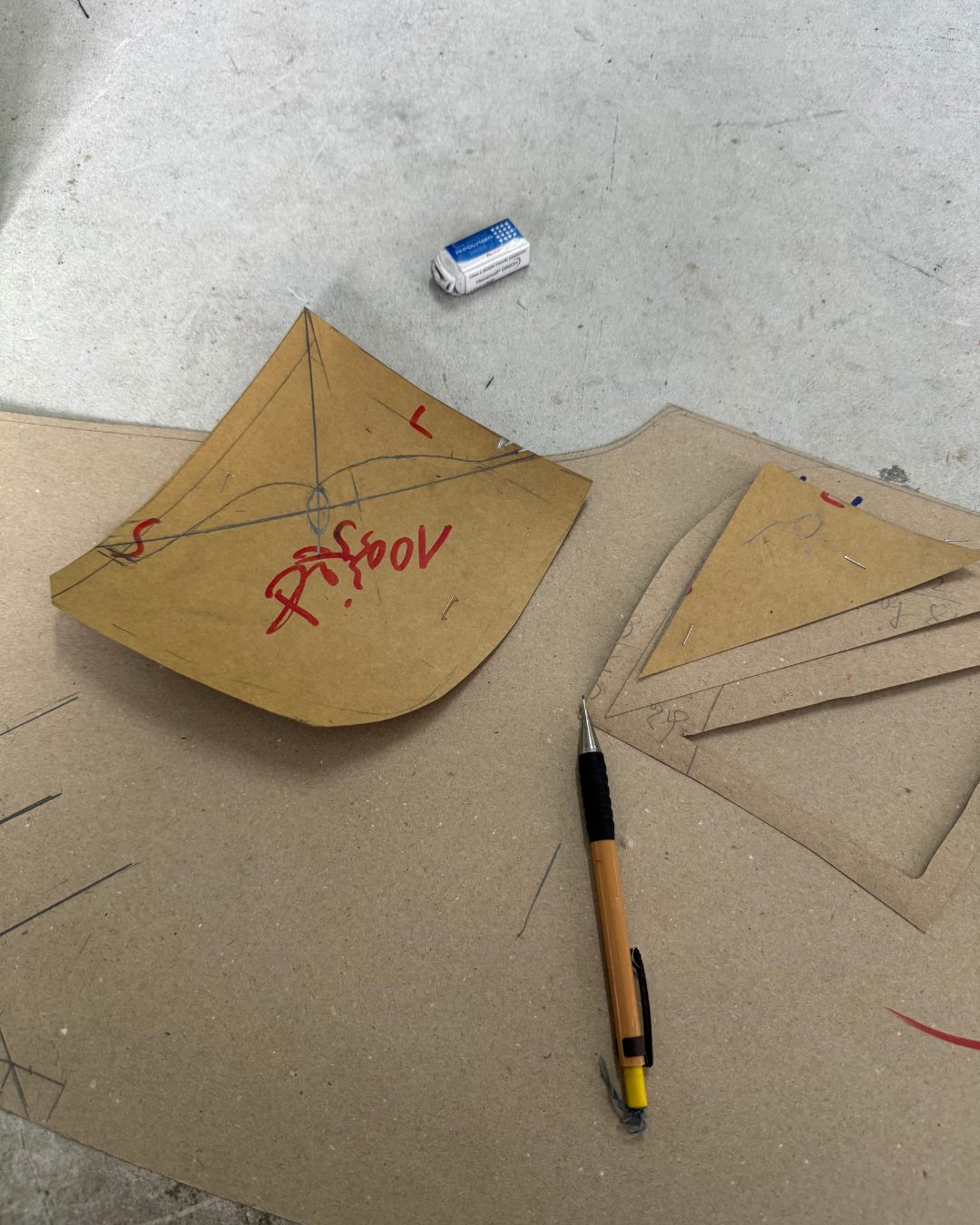 Hand-marked denim patterns on the cutting table